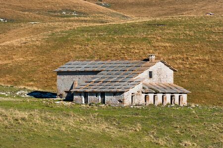 Typical farm house abandoned (Malga) in the plateau of Lessinia for the breeding of cows, Prealps of Veneto, Verona, Italyのeditorial素材