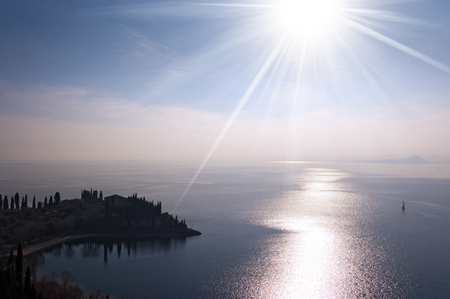 Punta San Vigilio, small promontory in the Garda Lake (Lago di Garda) with sun rays (backlight). Italy, Europeの写真素材