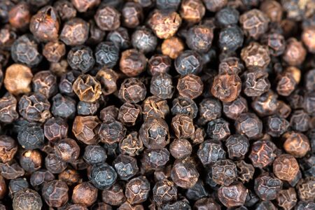 Background with many black peppercorns - Macro photographyの写真素材