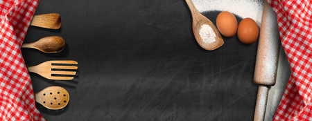 Baking background - Empty blackboard with wooden kitchen utensils, flour, eggs, rolling pin and red and white checkered tableclothの写真素材