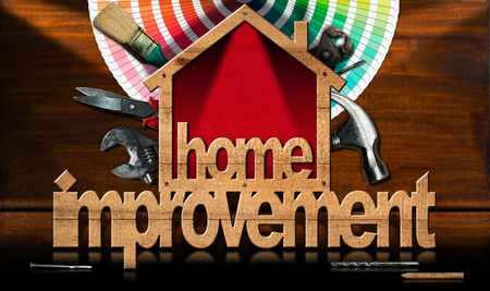 Home improvement - Wooden symbol in the shape of a house with a work tools and a color palette on a wooden deskの写真素材