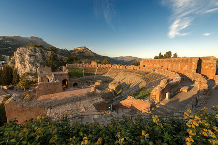 Ancient Greek Roman theater at sunset in Taormina town, Messina, Sicily island, Italy (II century AD)の写真素材