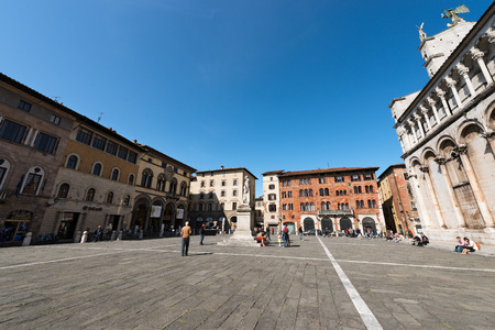 LUCCA, ITALY - APRIL 16, 2017: Piazza San Michele (Town square) with the Church (San Michele in Foro) and the medieval palaces. Lucca, Toscana (Tuscany), Italy, Europeのeditorial素材