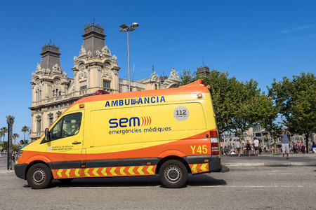 BARCELONA, SPAIN, JUNE 9, 2014: Yellow and Orange Ambulance in a downtown street of Barcelona. Emergency medical services in Spain, Cataloniaのeditorial素材