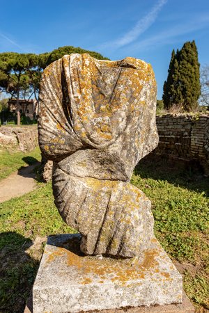 Ancient roman statue with tunic in Ostia Antica, Roman colony founded in the 7th century BC.の写真素材
