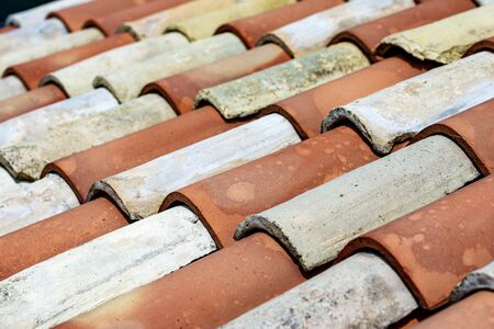 Closeup of an old house roof with a terracotta tiles (clay). Italy, Europe