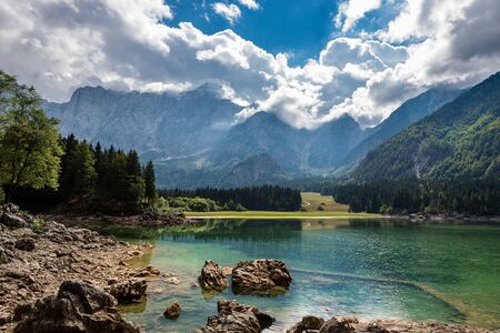 The small Fusine Lake (Lago di Fusine) and the Julian Alps, Mount Mangart, Tarvisio, Friuli Venezia Giulia, Italy, Europeの写真素材
