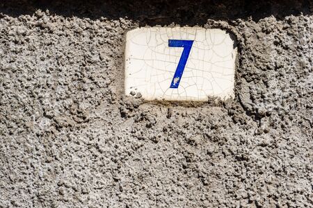 Old house number seven on the wall in a small village. Liguria, Italy, Europeの写真素材
