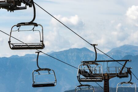 Empty chairlift with steel cables in mountain, Italian Alps, Passo Rolle,Trentino Alto Adige, Italy, south Europeの写真素材