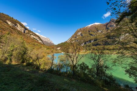 Lago di Tenno in autumn, small beautiful lake in Italian alps (Monte Misone). Trento province, Trentino-Alto Adige, Italy, Europeの写真素材
