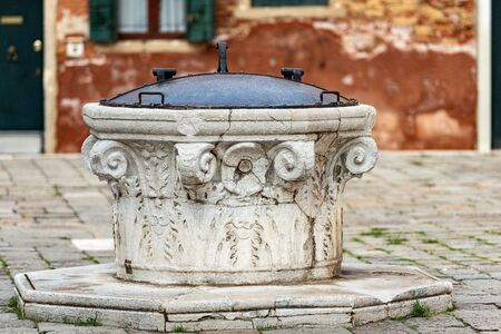 Venice, close-up of an ancient marble well for rainwater, Campo della Maddalena, UNESCO world heritage site, Veneto, italy, Europeの写真素材