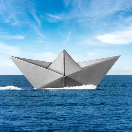 White paper boat runs fast over the blue sea with wake, sky with clouds on the backgroundの写真素材