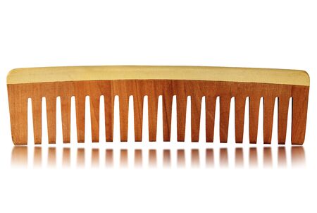 Close-up of a wooden comb for hair care isolated on a white background with reflections の写真素材