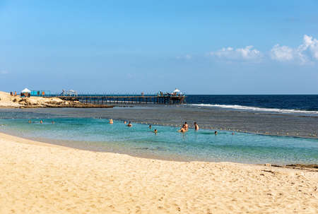 MARSA ALAM, RED SEA, EGYPT - NOV 3, 2018: Beautiful sandy beach and seascape with a pier above the coral reef used for diving or snorkeling. Red Sea near Marsa Alam, Egypt, Africa.のeditorial素材