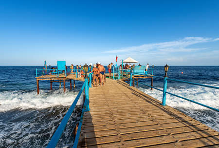 MARSA ALAM, RED SEA, EGYPT - NOV 1, 2018: Red Sea near Marsa Alam, Egypt, Africa. Wooden pier above the coral reef used for diving or snorkeling and seascape.のeditorial素材