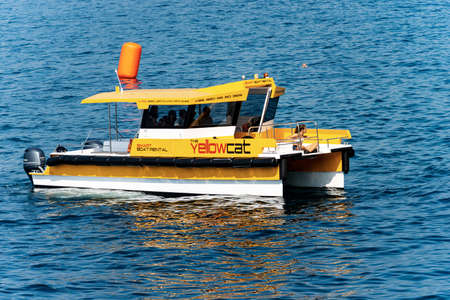 GULF OF LA SPEZIA, LIGURIA, ITALY - JULY 21, 2019: Yellowcat, yellow catamaran, a smart boat rental service, to visit the Mediterranean Sea along the coast of the Gulf of La Spezia and the Cinque Terre. Italy, Europeのeditorial素材
