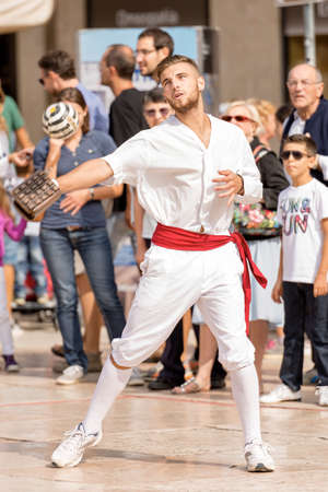 Tocati, International festival of street games. Athlete of Treia (Marche, Italy) does a demonstration of the game: ball with the bracelet - XVI centuryのeditorial素材