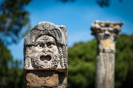 Stone theater mask from the decoration of the amphitheater in Ostia Antica, Roman colony founded in the 7th century BC. Rome Italy, Europeの写真素材