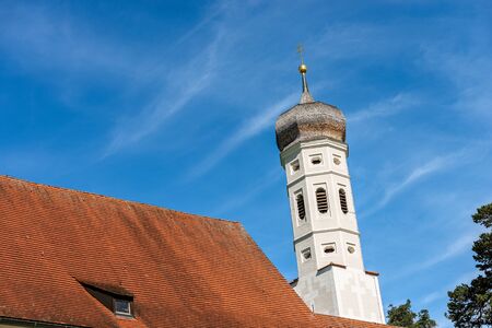 Colomanskirche or Saint Coloman Church, in Baroque style. Close-up of the bell tower and the roof. Schwangau, Allgau, Bavaria, Germanyの写真素材