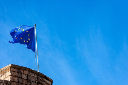 One European union flag waving in a blue sky with copy spaceの写真素材