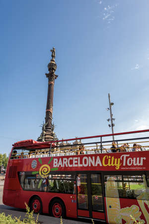 BARCELONA, SPAIN - JUNE 9, 2014: Red tourist bus in front of the Christopher Columbus Monument,...