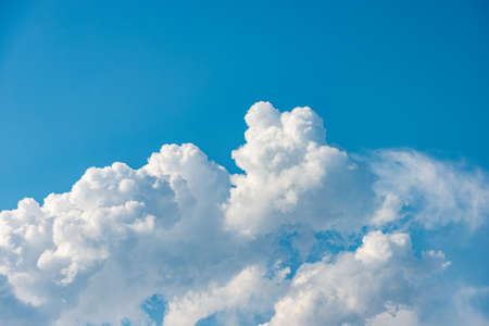 Closeup of a puffy white clouds in the blue sky, cumulonimbus