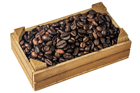 Closeup of roasted coffee beans in a small wooden crate, isolated on white background.の写真素材