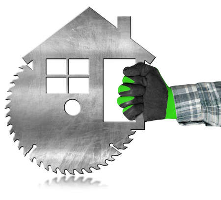 Carpenter with protective work gloves using an electric circular saw in the shape of a metal model house. Isolated on a white background with reflections.の写真素材
