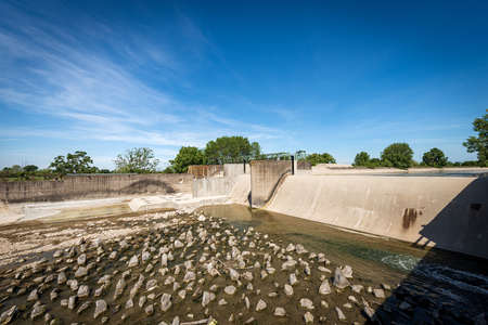 Reinforced concrete irrigation canal with dam of the River Mincio in the Padan Plain or Po valley (Pianura Padana, italian). Mantua province, Italy, southern Europe.の写真素材