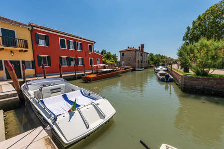 Port of Torcello island with many speed boats and two traditional water taxis made of wood moored. Venetian lagoon, Veniceの写真素材