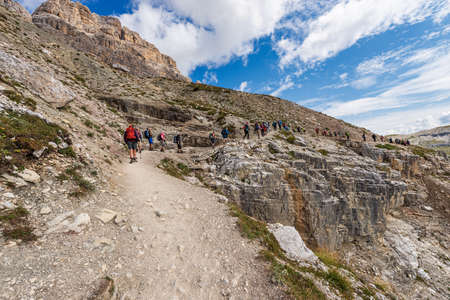 Large number of hikers on the path in front of the south face of the three peaks of Lavaredo (Drei Zinnen or Tre Cime di Lavaredo), Sesto Dolomites, Italy.のeditorial素材