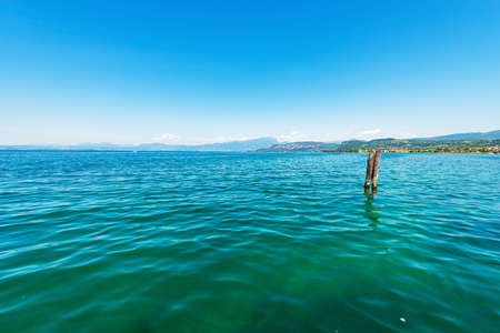 Panorama of Lake Garda (Lago di Garda) with the hills and mountains, from the Small Village of Bardolino, tourist resort in Verona province, Veneto, Italy, Europe. On the left the coast of Lombardy.の写真素材