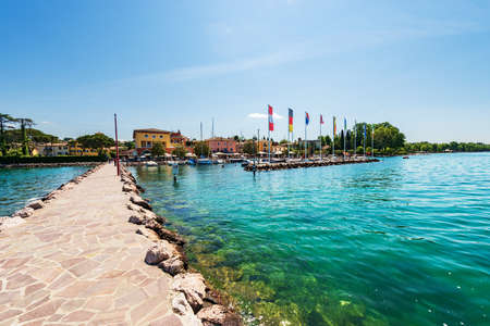 Small port of the village of Cisano with recreational boats moored. Tourist resort on the coast of Lake Garda (Lago di Garda). Bardolino municipality, Verona province, Veneto, Italy, southern Europe.の写真素材