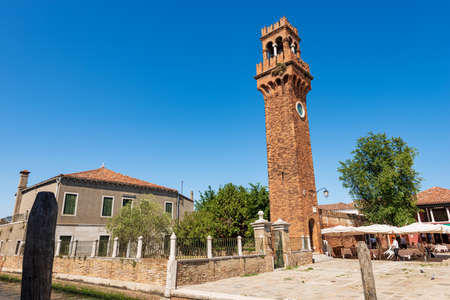 The ancient Civic Tower and Clock Tower in Murano island in medieval style. Campo Santo Stefano (urban square), Venice, UNESCO world heritage site, Veneto, Italy, Europe.のeditorial素材