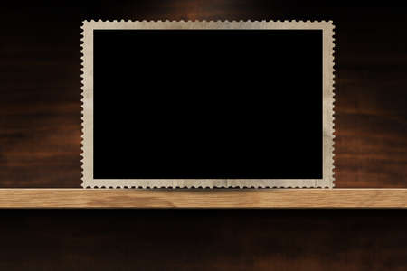 Closeup of an empty old fashioned photo frame on a wooden shelf. Photography.