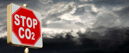 Closeup of a modern Stop road sign of CO2 (carbon dioxide), with a sky with pollution on background. Reduce greenhouse gas emission for climate change and sustainable development.の写真素材