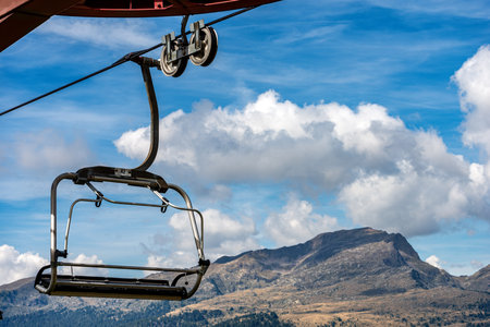 Close-up of a empty chairlift with steel cables in mountain, Italian Alps, Passo Rolle,Trentino Alto Adige, Italy, south Europeの写真素材