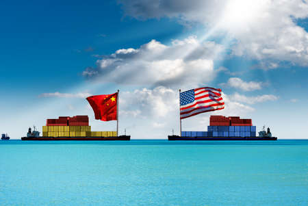 USA and China trade war concept. Two cargo container ships with the chinese and United states of America flag, in a turquoise sea with blue sky, clouds and sun raysの写真素材