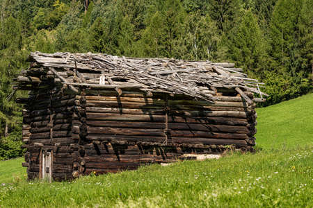Close-up of an old wooden barn with broken roof in mountain, Val di Fiemme, Bellamonte village, Predazzo, Trentino Alto Adige, Italy, Europeのeditorial素材