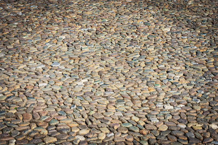 Close-up of a paving stone made of small cobblestones in Brescia downtown, Piazza della Loggia...
