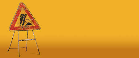 Men at work or work in progress, old and rusty road sign on a yellow and orange background with copy...