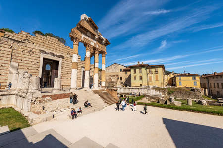 Ancient ruins of the Capitolium Roman Temple (Tempio Capitolino) with tourists, in Brescia downtown, 73 AC, UNESCO world heritage site, Lombardy, Italy, Europe.のeditorial素材