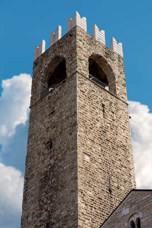 Brescia. Ancient medieval tower (Torre del Popolo o del Pegol) of the Broletto Palace (Palazzo Broletto), XII-XXI century, town square called Piazza Paolo VI, Lombardy, Italy, Southern Europe.のeditorial素材