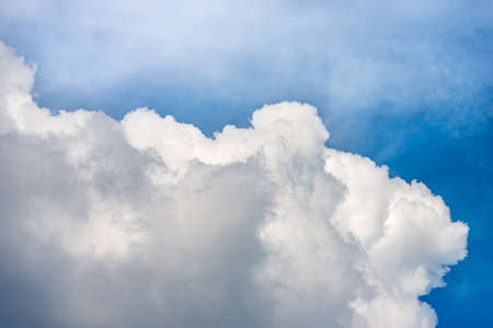 Beautiful storm clouds, cumulus clouds or cumulonimbus against a clear blue sky. Photography, full frame, sky only.の写真素材