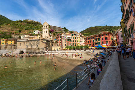 Sandy beach of the ancient Vernazza village crowded with tourists on a hot and sunny summer day. Cinque Terre, National park in Liguria, La Spezia, Italy, Europe.のeditorial素材