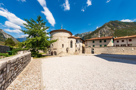Venzone Baptistery or Chapel of San Michele, with the crypt of the mummies, in front of the medieval Cathedral, Church of St. Andrew the Apostle, 1308. Udine, Friuli-Venezia Giulia, Italy, Europe.の写真素材