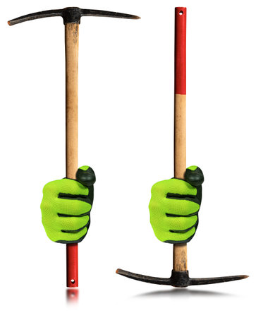 Closeup of a hand with protective work glove holding a Pickaxe or Pick ax, isolated on white background with reflection. Hand tool used for digging.の写真素材