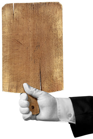 Hand of a waiter with white work glove holding an old wooden cutting board, isolated on white background with copy space.の写真素材