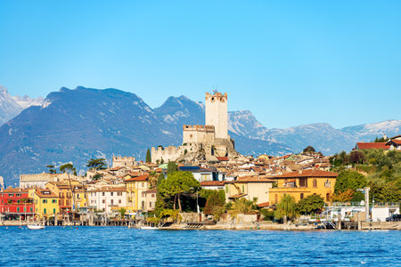Lake Garda (Lago di Garda) with the small ancient Malcesine village. Verona province, Italy, Veneto, southern Europe. In the background the coast of the Lombardy.の写真素材