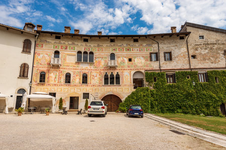 Ancient Spilimbergo castle in Gothic-Renaissance style, medieval origins - XV century, main facade with numerous frescoes. Pordenone province, Friuli-Venezia Giulia, Italy, Europe.のeditorial素材
